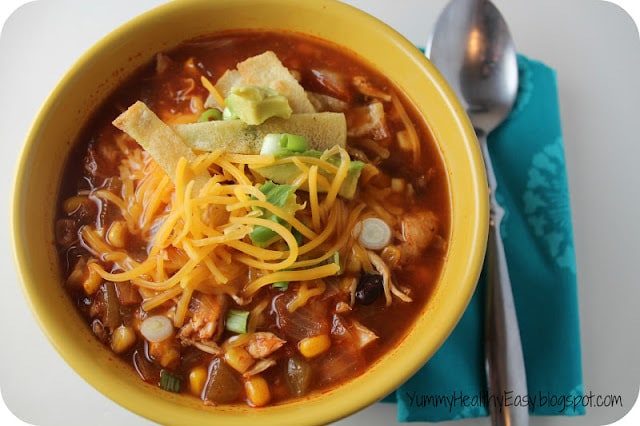 Healthy Chicken Tortilla Soup cooked right in the crock pot for an easy and delicious dinner! Tender chicken, beans and corn in a flavorful broth served with homemade crispy tortilla strips. Yum!