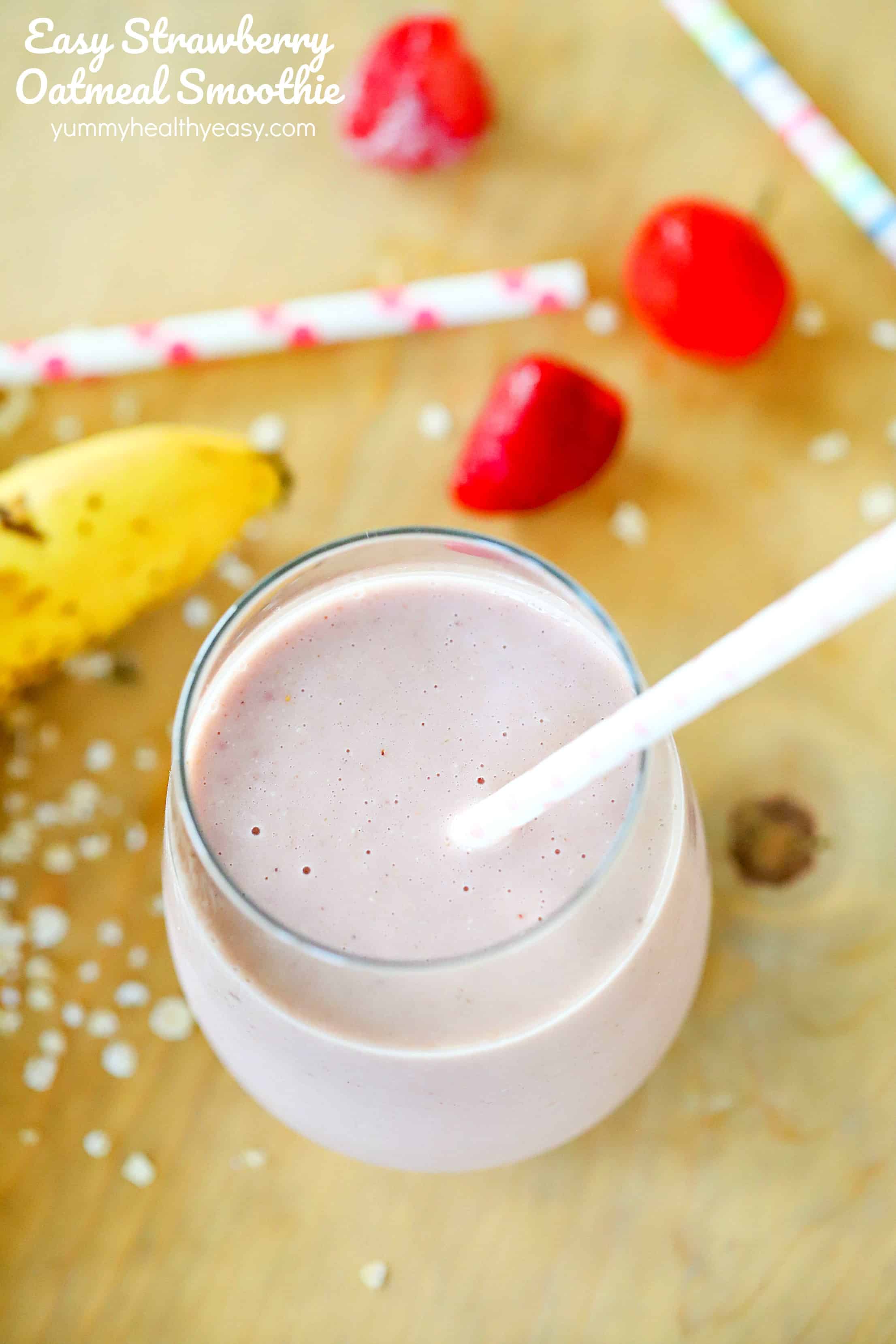 Overhead view of a strawberry oatmeal smoothie with a background of bananas and strawberries, straws and oats with the title written on the top left.