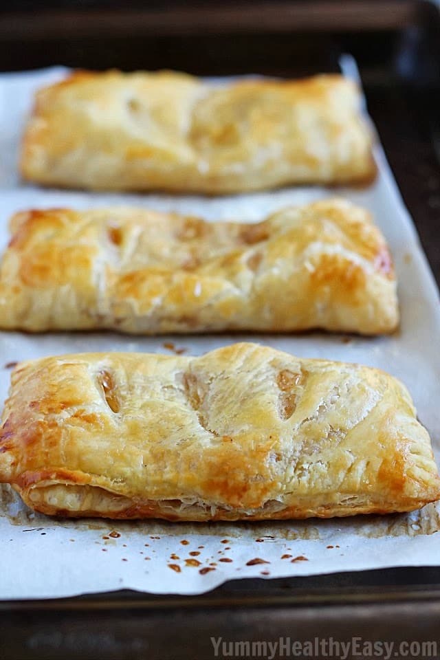 Easy Apple Hand Pies | flaky puff pastry squares filled with homemade (easy) apple pie filling. They're a simpler alternative to apple pie that you can hold in your hand! Apple Hand Pies