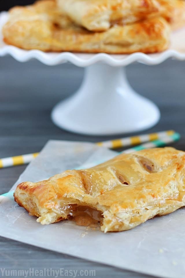 Easy Apple Hand Pies | flaky puff pastry squares filled with homemade (easy) apple pie filling. They're a simpler alternative to apple pie that you can hold in your hand! Apple Hand Pies