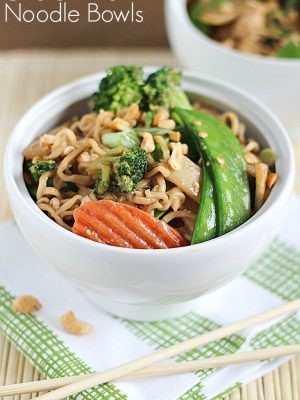 A new spin on ramen noodles - Chicken Thai Noodle Bowls! Ramen noodles and stir-fry veggies tossed in a quick & easy peanut sauce and topped with chopped peanuts and green onions. Delicious!