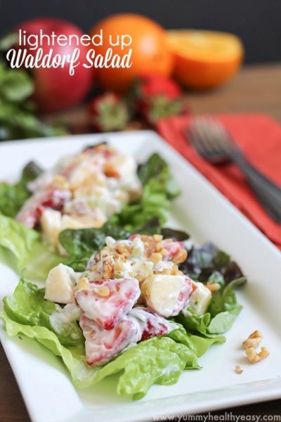 Lightened Waldorf Salad on lettuce leaves on a white plate.