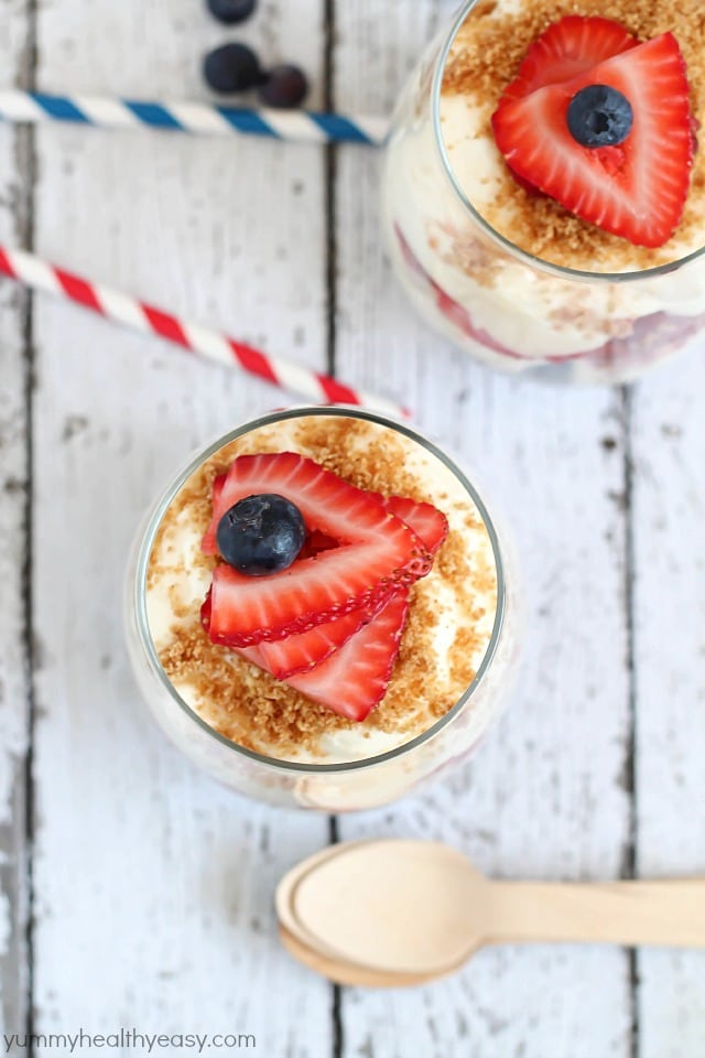 No-Bake Cheesecake Parfaits - layered with graham cracker crumbs, sliced strawberries, blueberries and easy no-bake cheesecake filling. Perfect for 4th of July!