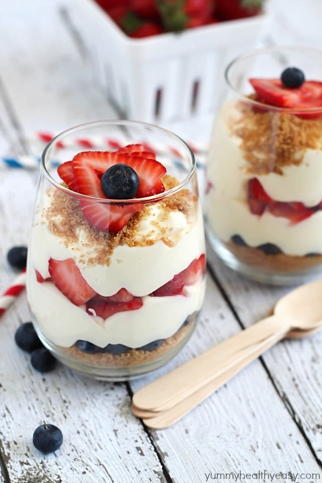 No-Bake Cheesecake Parfaits - layered with graham cracker crumbs, sliced strawberries, blueberries and easy no-bake cheesecake filling. Perfect for 4th of July!