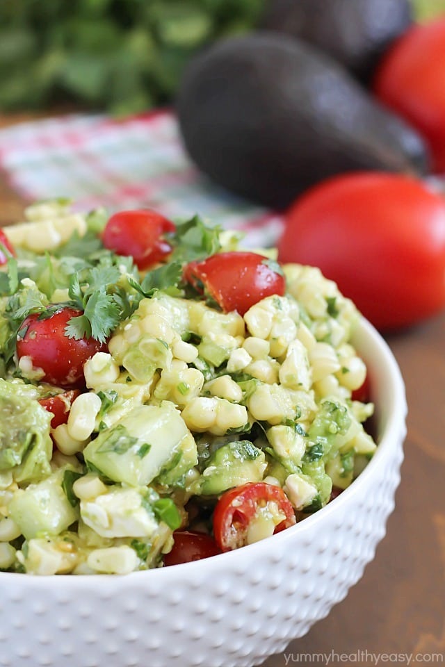 Delicious grilled corn mixed together with avocado, tomato, feta, green onions, cilantro and cucumber then tossed in an easy dressing. The perfect refreshing side dish for a BBQ!