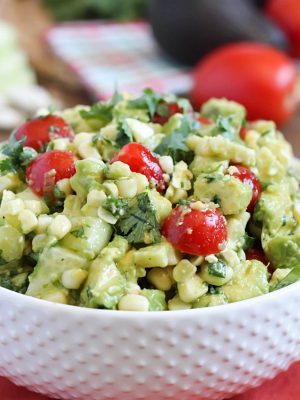 Delicious grilled corn mixed together with avocado, tomato, feta, green onions, cilantro and cucumber then tossed in an easy dressing. The perfect refreshing side dish for a BBQ!