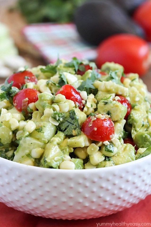 Delicious grilled corn mixed together with avocado, tomato, feta, green onions, cilantro and cucumber then tossed in an easy dressing. The perfect refreshing side dish for a BBQ!