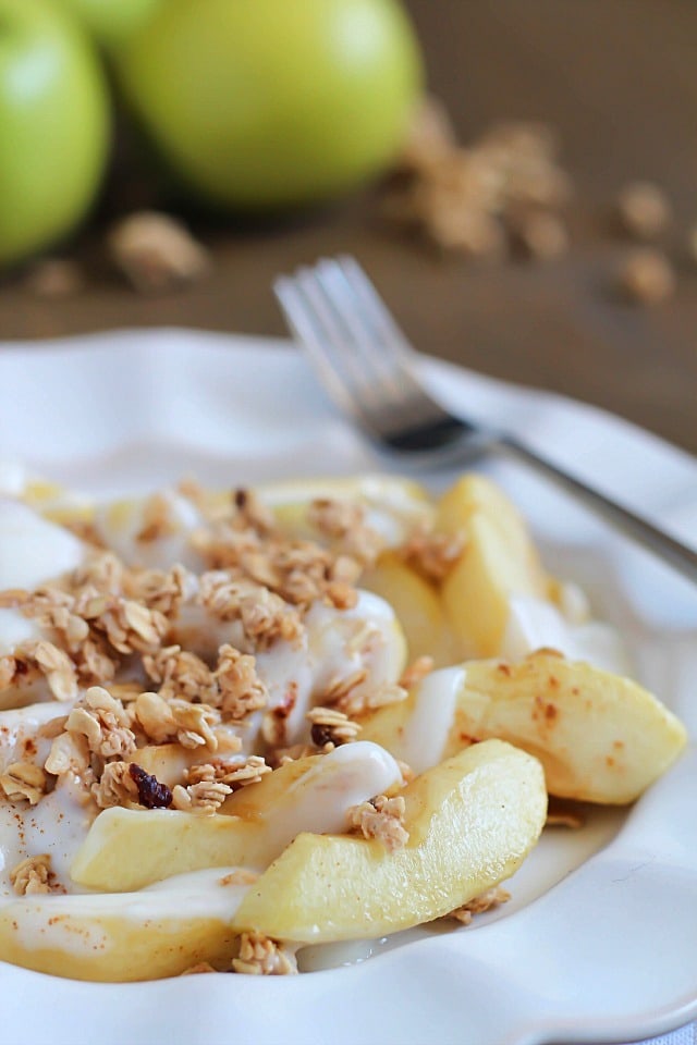 Baked Apples tossed in maple syrup and served with spiced yogurt and granola. Easy and healthy dessert, snack or breakfast!