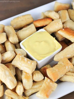 Pretzel Bites dunked in an EASY honey mustard dipping sauce...perfect for noshing after school or while watching a football game!