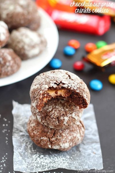 Chocolate Surprise Crinkle Cookies filled with pieces of your favorite candy inside and rolled in powdered sugar - the best way to use up any leftover candy!