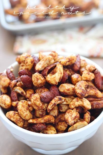 A white bowl overfilled with Healthy Spiced Nuts! Yum!