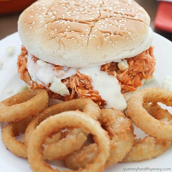 You will love these 3-ingredient Crock Pot Buffalo Chicken Sandwiches! Shredded buffalo chicken inside buns and smothered with blue cheese and hot sauce. So easy and absolutely delicious!