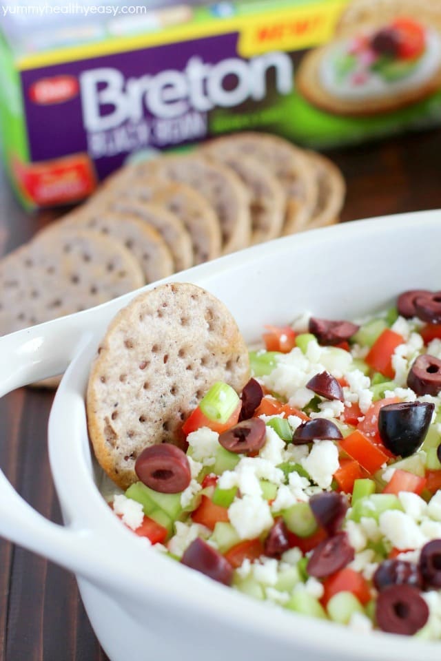 Deliciously healthy greek dip, made with a protein-rich cottage cheese base (with ranch seasonings!) then topped with cucumbers, green onions, tomatoes, kalamata olives, and feta cheese. Healthy and full of flavor! #breton #ad