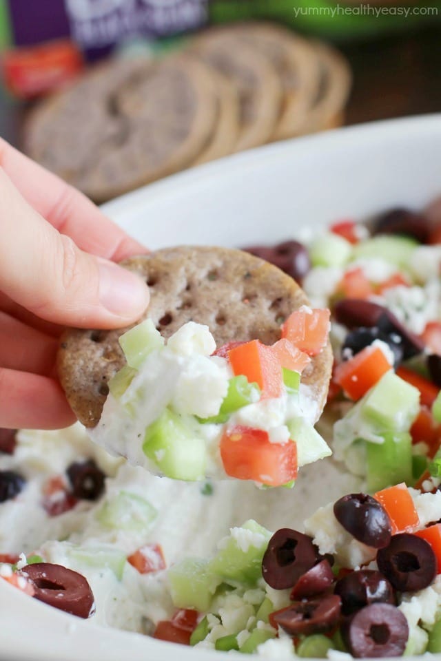 Deliciously healthy greek dip, made with a protein-rich cottage cheese base (with ranch seasonings!) then topped with cucumbers, green onions, tomatoes, kalamata olives, and feta cheese. Healthy and full of flavor! #breton #ad