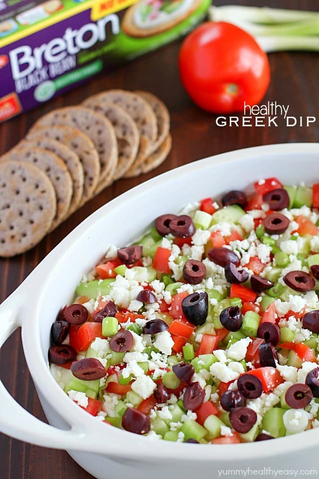 Deliciously healthy greek dip, made with a protein-rich cottage cheese base (with ranch seasonings!) then topped with cucumbers, green onions, tomatoes, kalamata olives, and feta cheese. Healthy and full of flavor! #breton #ad #breton #ad