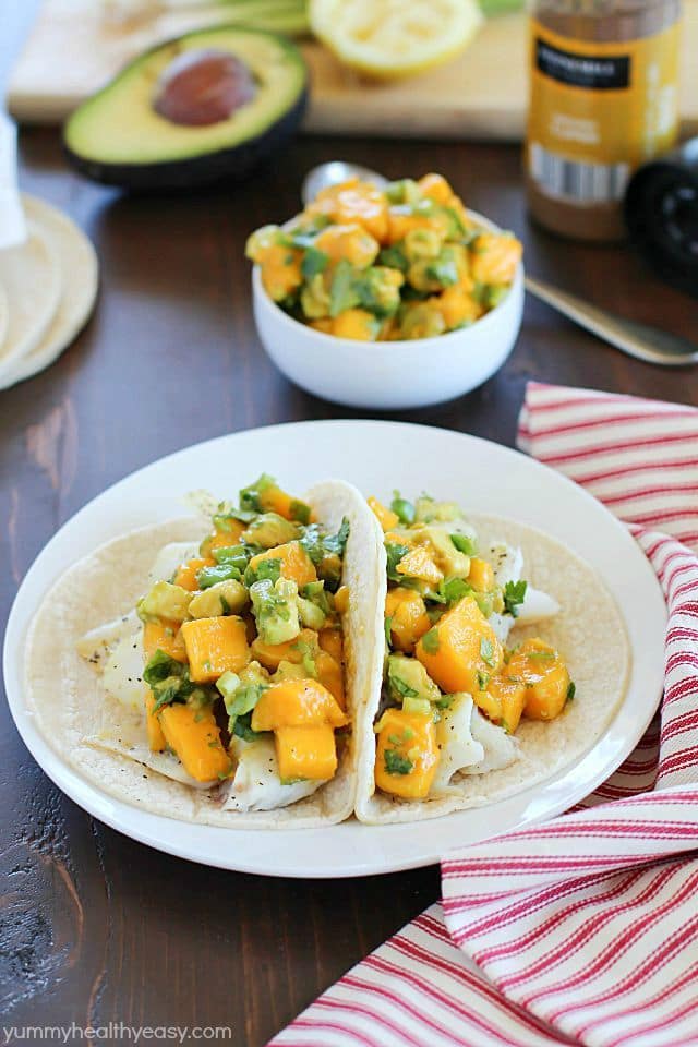 You will love these Fish Tacos with Mango Salsa! Corn tortillas filled with flaky white fish and topped with fresh mango and avocado salsa. Doesn't get better than that! #ad