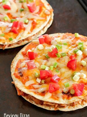 Tray with two Mexican Pizzas. Easy, yummy recipe of layered flour tortillas with a filling of refried beans, shredded chicken and salsa.