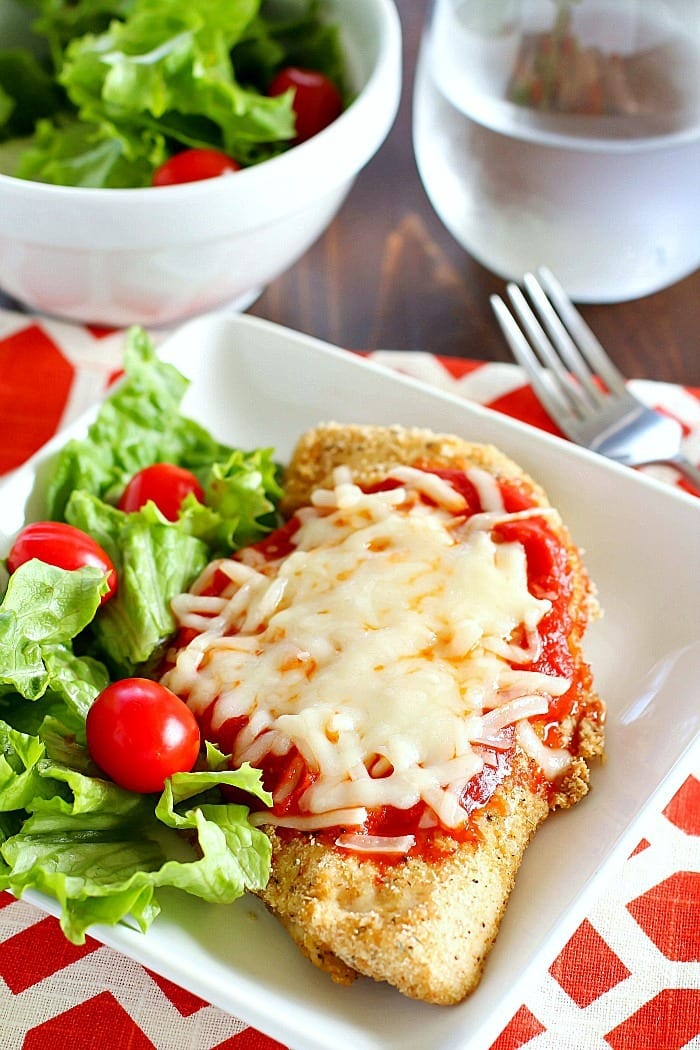 Time to change up that fattening Chicken Parmesan Recipe and make it skinny!! This lightened up comfort food dish is super easy to make and made healthier by baking instead of frying among other things. You need to add this Skinny Chicken Parmesan to your weekly dinner rotation!