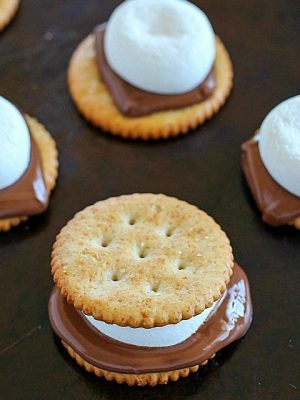 Oven S'mores Sandwiches for the WIN! You don't need a campfire to enjoy s'mores, make them in the oven instead! These oven smores are incredibly easy to make (about 5 minutes total!) and are the perfect combo of salty and sweet. So delicious! AD