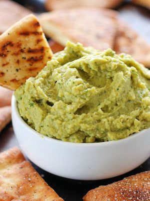 Avocado Hummus with Homemade Pita Chips - you will go crazy for the combo of avocado, garbanzo beans and spices! Dip in some easy homemade pita chips, and you have yourself a healthy, flavorful snack!