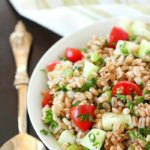 Farro Salad full of tender farro, tomatoes, cucumber, green onions, parsley, and tossed in an olive oil & lemon dressing. Super easy and delicious side dish! With a delicious mix of flavors and textures - I will be making this farro salad again and again and again. :)