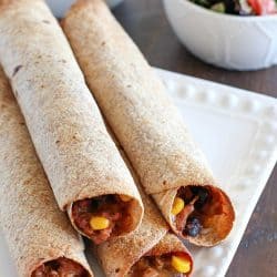 Need a light & easy dinner? Try this Skinny Baked Mexican Flautas Recipe! They're made lighter with a few ingredient swaps and are baked instead of fried. They are incredibly delicious! Whole Wheat tortillas filled with lean ground turkey, corn, black beans, refried beans, cheese, and lots of spices!! Super yummy dinner recipe!