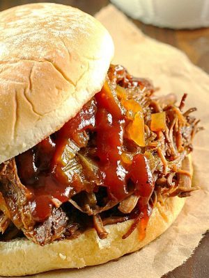 Slow Cooker Shredded Beef Sandwiches are one of my family's favorite make-ahead dinners! Cooked right in the crock pot with an easy & flavorful sauce, makes this beef roast tender and perfect for filling sandwiches/buns! Great to serve for dinner or for a party!