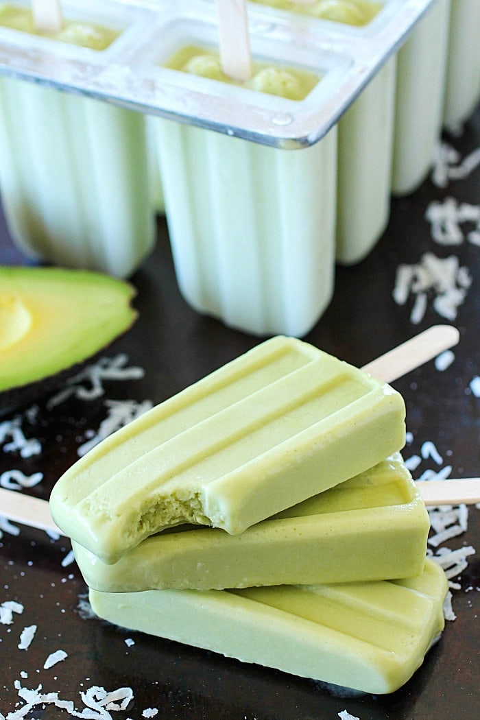 Creamy Avocado Coconut Popsicles - every bite is a tropical getaway! Who would have thought that avocado in a popsicle would be so delicious? You get a little coconut, lime and avocado in every bite of these popsicles! AD