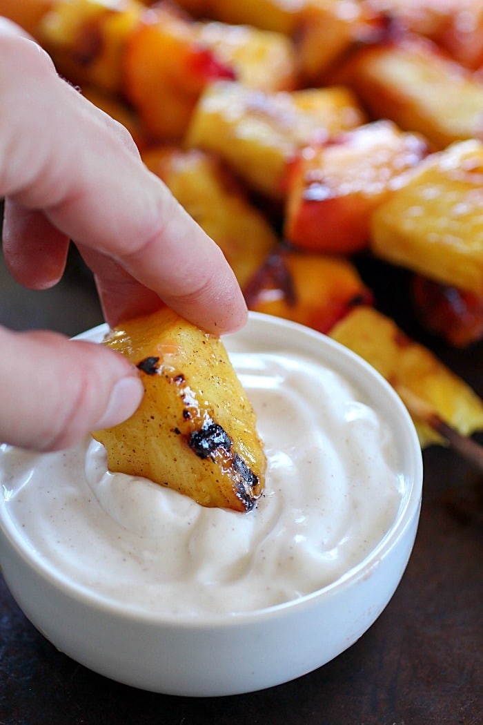 Fruit Skewers are grilled with a sweet cinnamon glaze and dipped in a delicious easy yogurt dip! You will go crazy for these grilled fruit skewers! AD