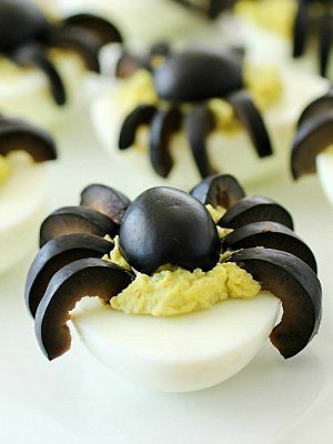 Celebrate Halloween with Spooky Spider Avocado Deviled Eggs! Your party guests will love these creepy crawly olive spiders on top of ghoulishly green avocado deviled eggs! AD