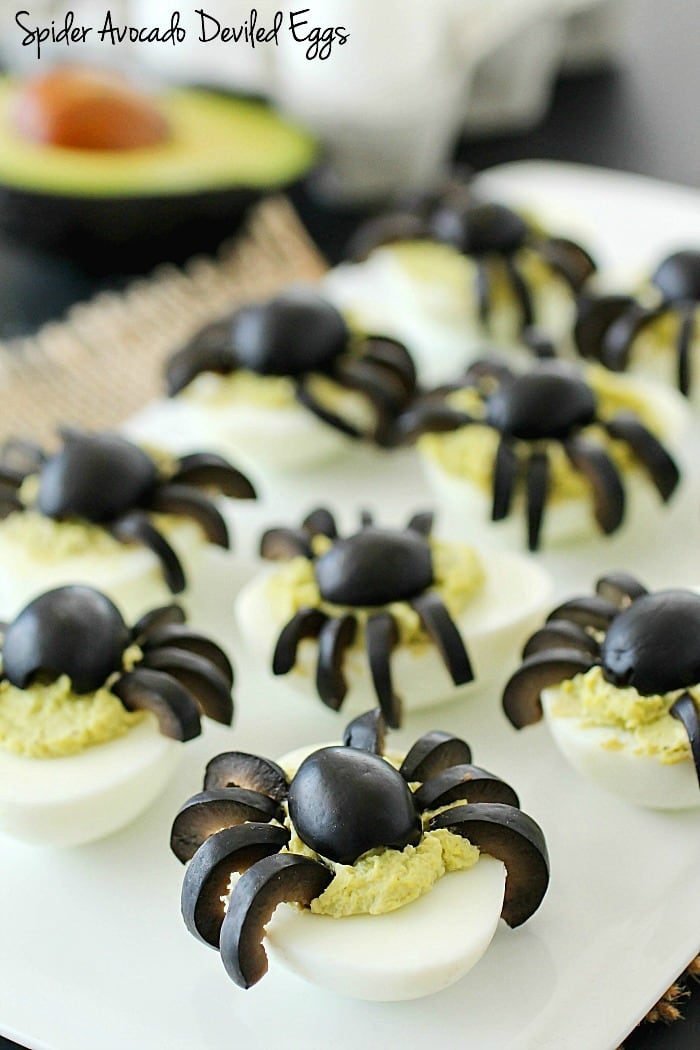 Celebrate Halloween with Spooky Spider Avocado Deviled Eggs! Your party guests will love these creepy crawly olive spiders on top of ghoulishly green avocado deviled eggs!