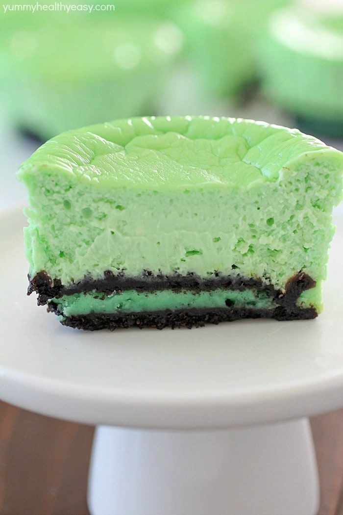 Skinny Mini Mint Cheesecakes with an Oreo crust! This lighter mint cheesecake recipe is super easy to make and you only need a few ingredients to whip up a batch. These cute cheesecakes have less calories than a regular cheesecake plus built-in portion control with the muffin size!
