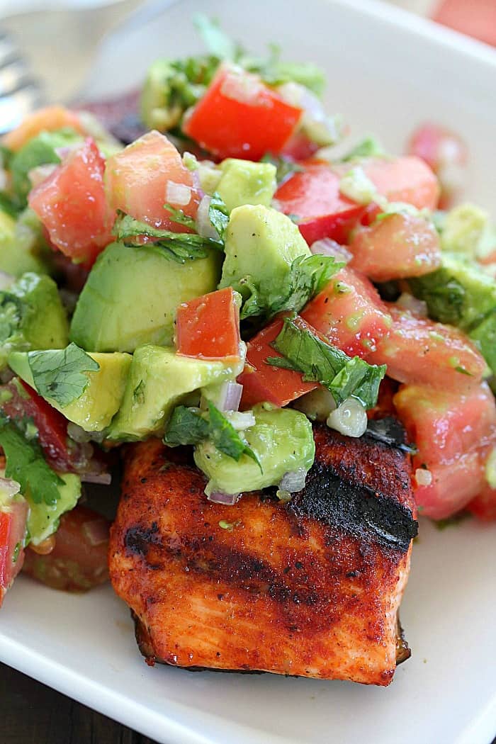 This Spicy Grilled Salmon has an easy to make, sweet/spicy rub that everyone will love! Topped with Avocado Salsa, this dinner is sure to please!
