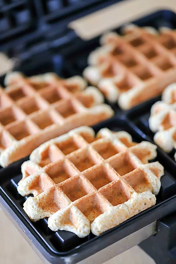 Finished waffle cookie coming out of a waffle iron
