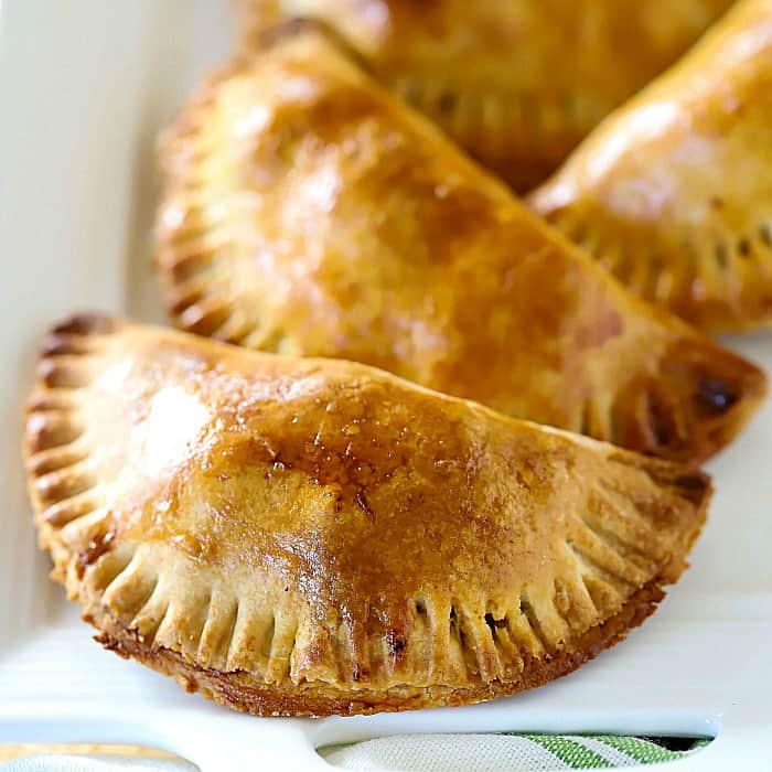 Square photo of a browned, cooked empanada