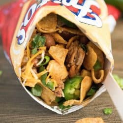 Close up of a Frito snack size bag filled with taco mixture and toppings. Yum!