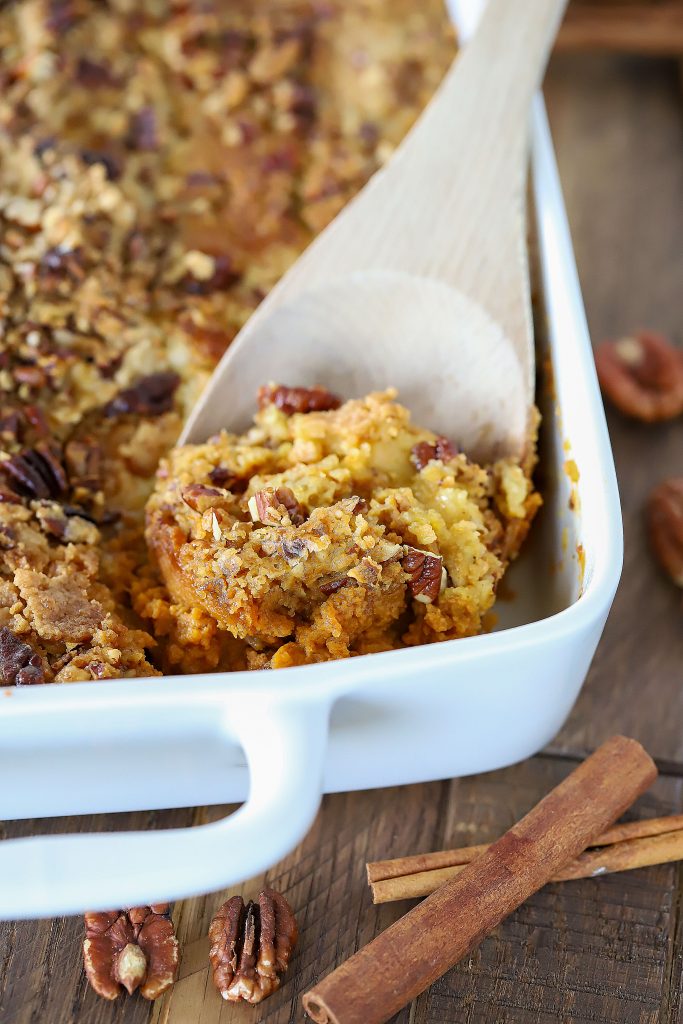 Rectangle casserole dish with a wooden spoon getting a scoop out.